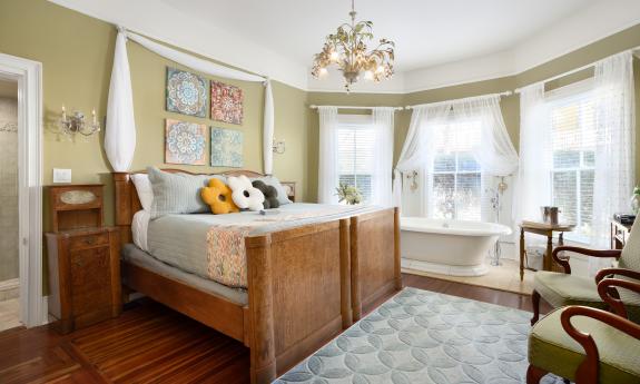 One of the rooms in this bed and breakfast features whimsical pillows shaped like flowers