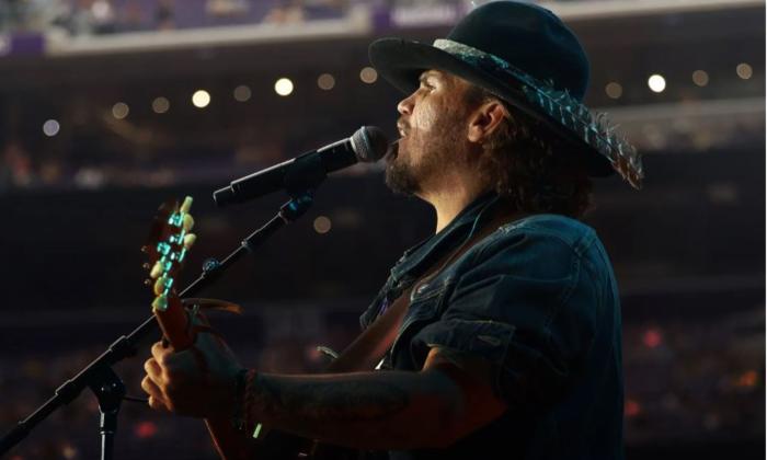 Bryan Martin performs live on stage for fans. 