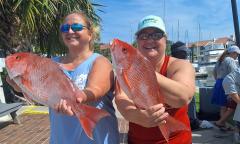 Two women with a fresh catch of redfish