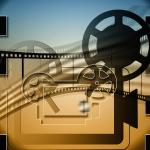 Depiction of movie projector with film over the top of it