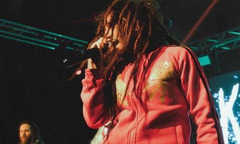 Bandmates from Korn Again perform live on stage.
