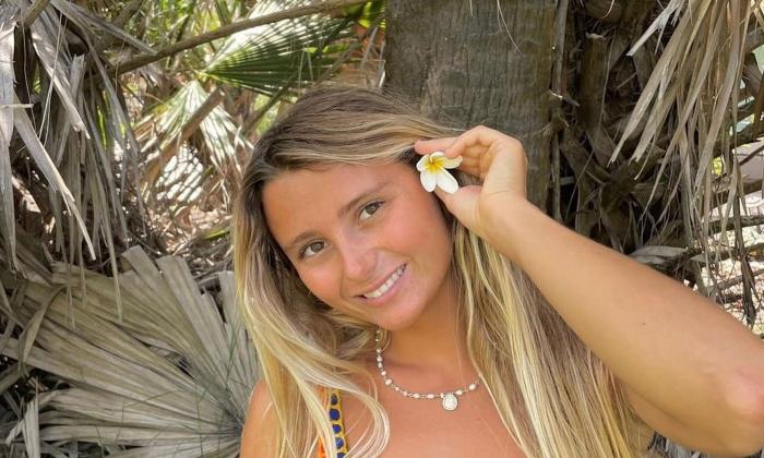 Musician Lucy Spotts with flower in hair, smiling