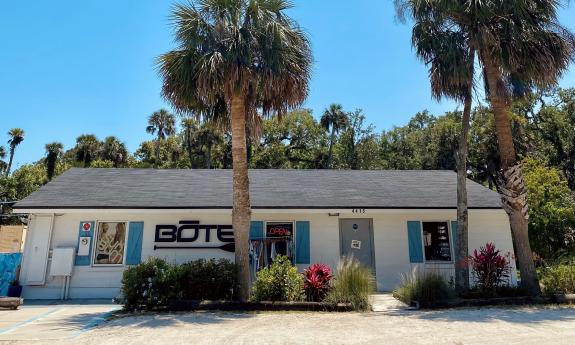 The main store for North Guana Outpost is a low white building with blue trim