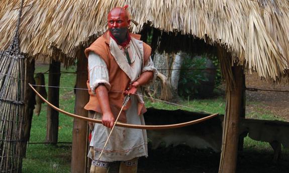 A historical reenactor portrays a Timucuan at the Fountain of Youth's Village of Seloy in St. Augustine.