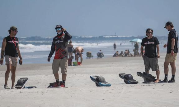 The Witz Wheel crew enjoying a day on the beach with their OneWheels